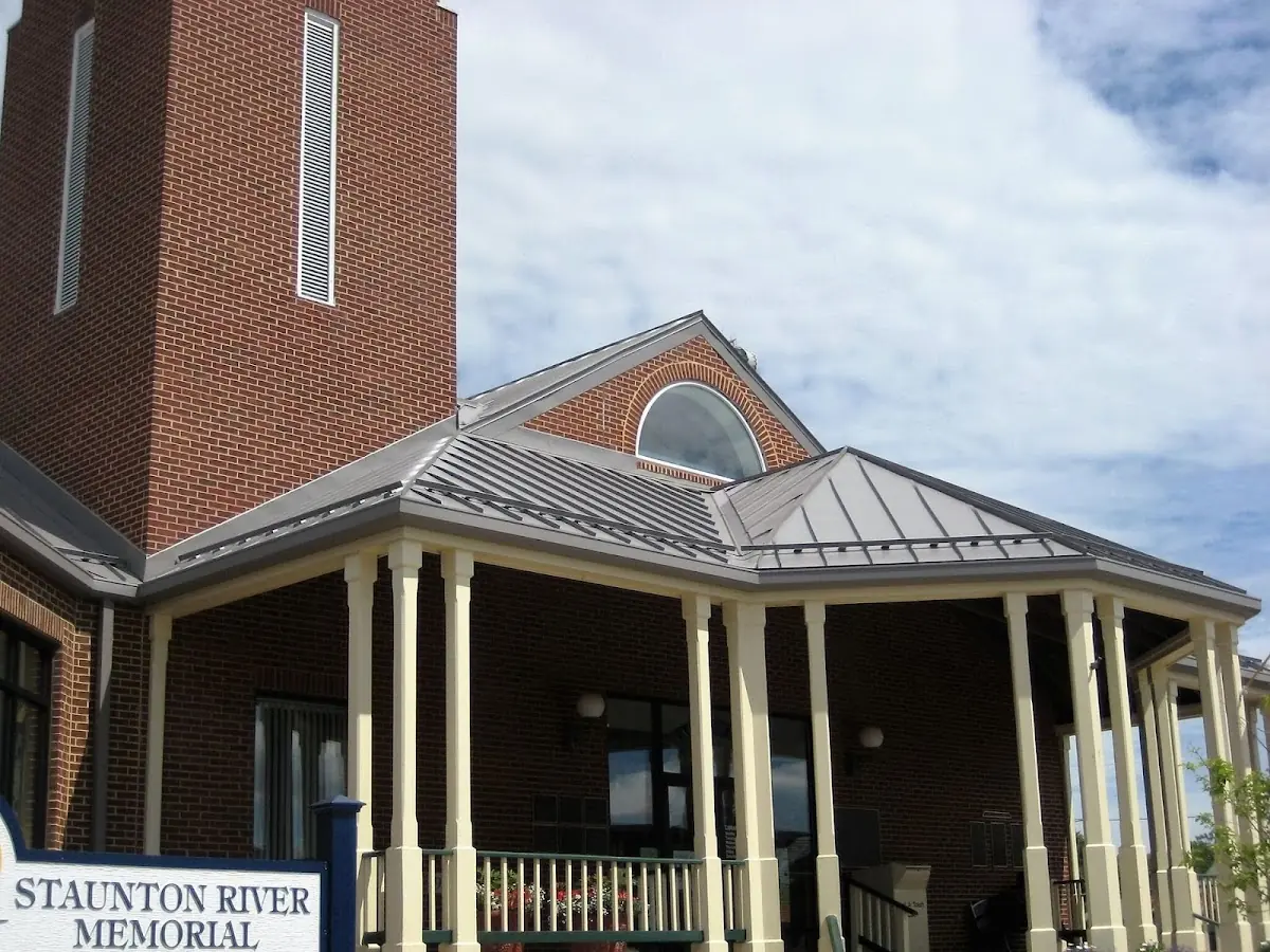 Skilled roofing craftsmen working on a residential roof in Van Buren